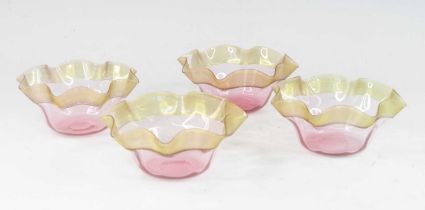 A set of four Stevens and Williams amber and cranberry glass bowls, circa 1880, each having a wavy