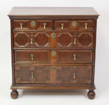 A Jacobean period and later oak chest, having a replacement top above two short and three long