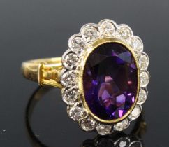 An 18ct yellow gold, amethyst and diamond oval cluster ring, featuring a centre oval amethyst within