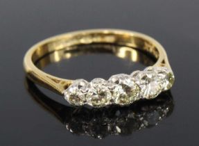 A yellow and white metal diamond half hoop eternity ring, comprising five graduated round