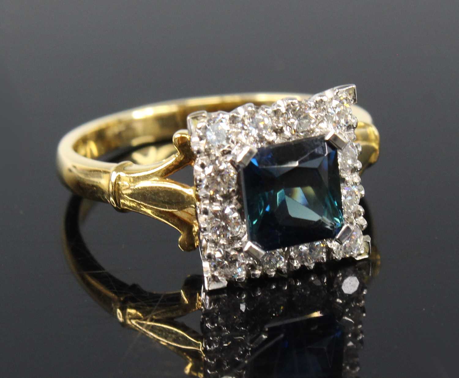An 18ct yellow and white gold, synthetic sapphire and diamond square cluster ring, featuring a