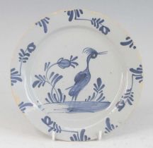 A Lambeth or Bristol Delftware plate, mid 18th century, decorated with a heron amongst foliage,