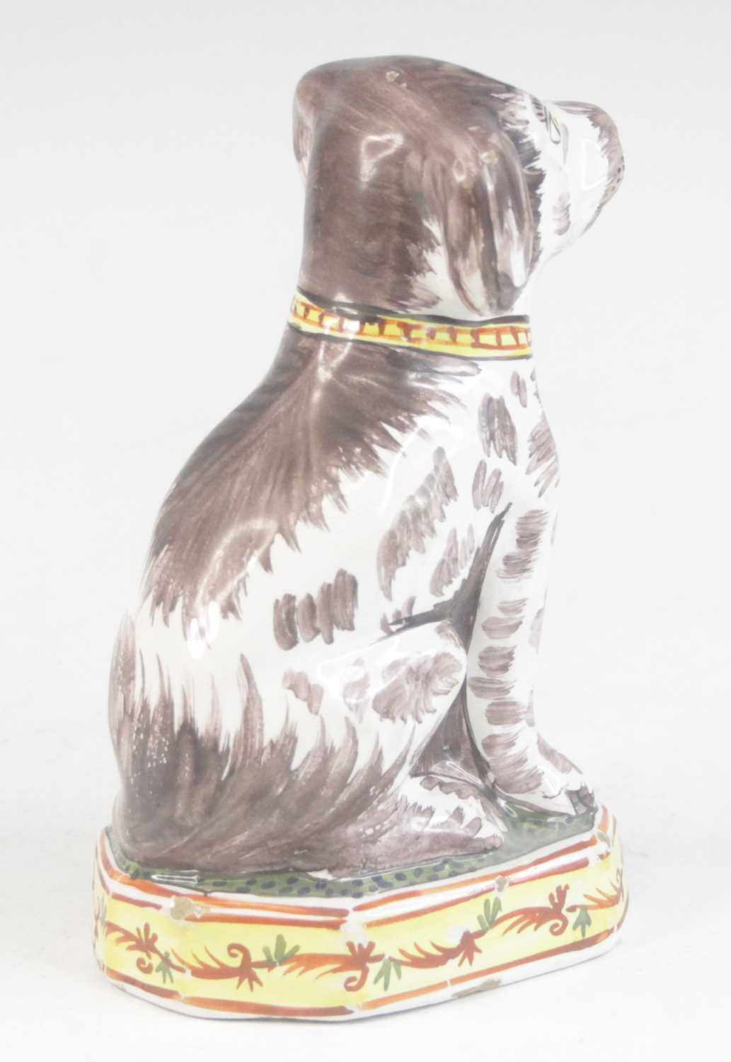 A Delft or Faience polychrome model of a dog, shown seated upon a canted plinth, PAK monogram to the - Image 4 of 5