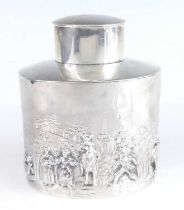 An Edwardian silver tea caddy, of oval form with undecorated oval cover, the body repousse decorated