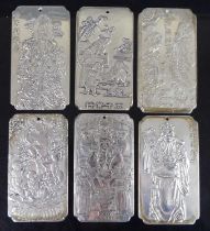 A collection of six Chinese silver ingot pendants / scroll weights, each of shaped rectangular form,