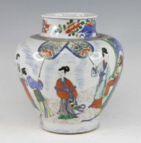A Chinese wucai vase, of baluster form, enamel decorated with figures within a fenced garden, h.26cm