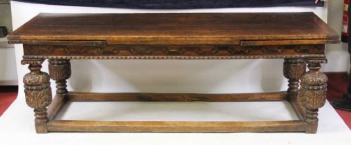An antique oak drawleaf refectory table in the Elizabethan style, the four plank top with cleated
