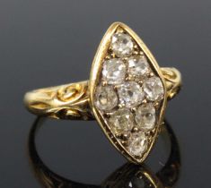 A late Victorian yellow metal diamond navette shaped cluster ring, comprising nine old cushion cut