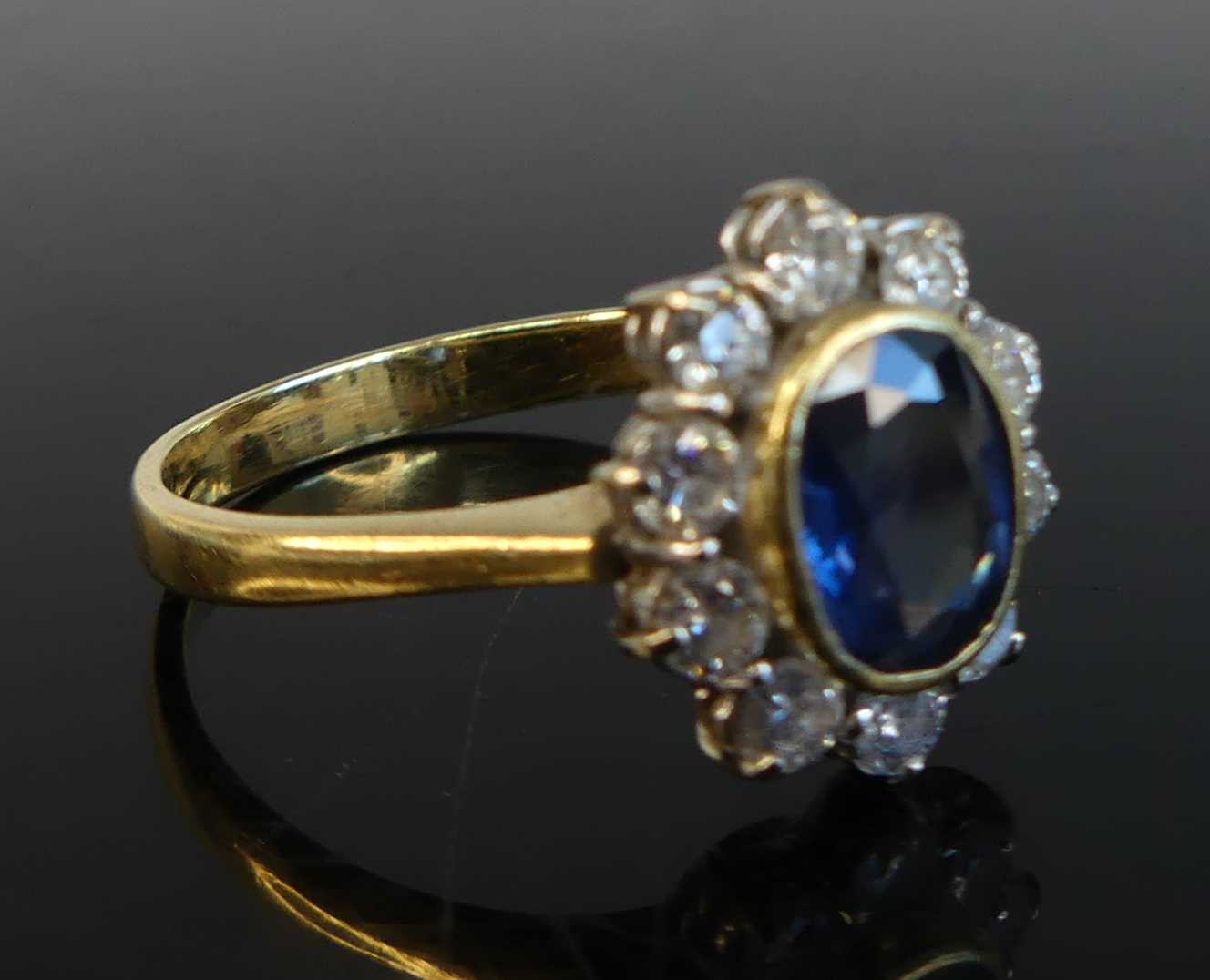 An 18ct yellow and white gold sapphire and diamond oval cluster ring comprising a centre sapphire - Image 2 of 8