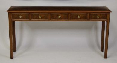 A walnut and figured walnut hall table in the 18th century style, having a feather and crossbanded