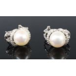 A pair of 9ct white gold, cultured pearl and diamond earrings, each with a 10.35mm cultured pearl