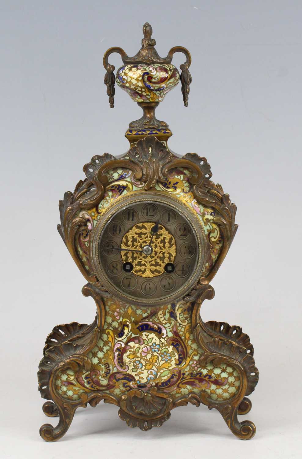 A late 19th century French gilt brass and champleve enamel fronted balloon shaped mantel clock,