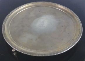 A George III silver salver, of circular form with a stepped rising edge and gadrooned rim, the