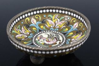 A white metal and enamel footed small bowl, probably Russian, decorated in bright enamel with