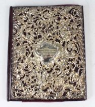 A Victorian silver mounted desk blotter, the applied high relief repousse cover decorated with