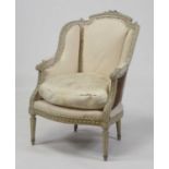 A circa 1900 French white painted fauteuil, upholstered but for re-covering, having a leaf carved