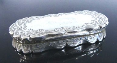 A Victorian silver snuff box, of shaped rectangular form with hinged cover, all-over bright cut