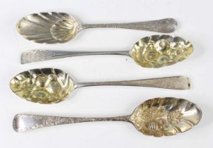 A pair of George III silver berry spoons, each with gilt-washed bowls and engraved terminals,