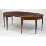 A George III mahogany double D-end dining table, the top having a single leaf, satinwood crossbanded
