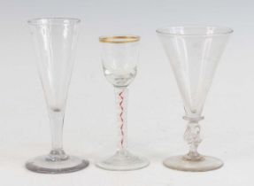 A wine glass, circa 1770, the round funnel bowl above a red and white corkscrew stem, h.14cm,