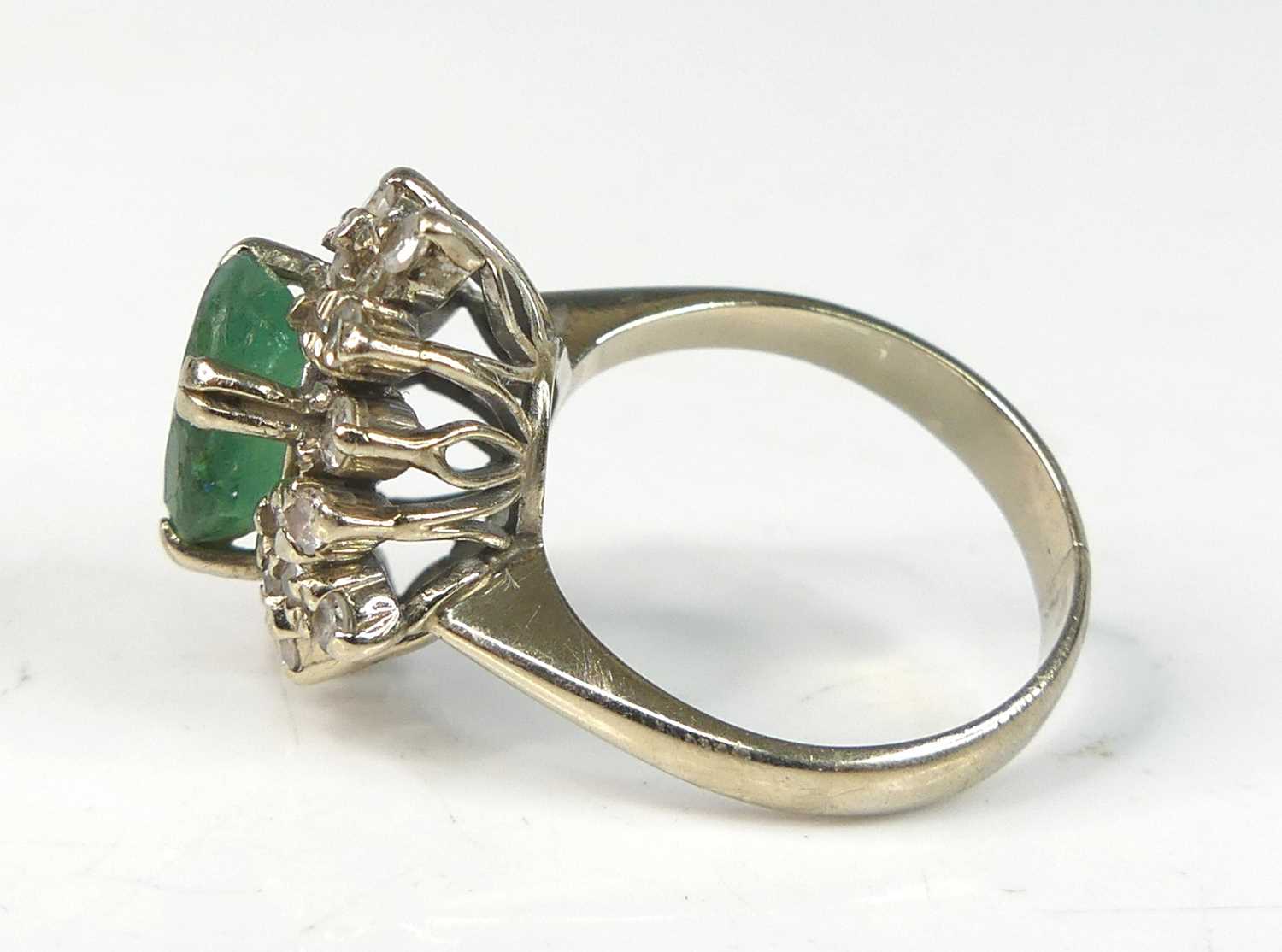 A white metal, emerald and diamond oval cluster ring, comprising a centre oval emerald within a - Image 4 of 7