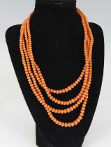 A four-row coral necklace, with 111, 113, 119 and 131 4.25 to 6.9mm coral beads, strung plain to a