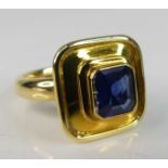 An 18ct yellow gold sapphire heavy dress ring, featuring an octagonal cut sapphire bezel set