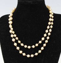 A single row necklace of 76 5.35 to 8.65mm baroque cultured pearls, strung knotted to a white