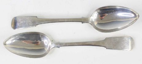 A pair of late Georgian silver tablespoons, in the Fiddle pattern, each having double monogrammed