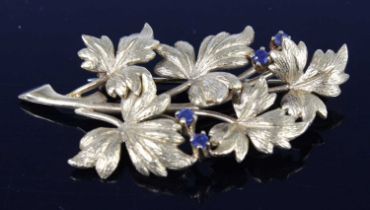 An 18ct yellow gold stylised leaf spray brooch, having four 2.25mm round sapphire accents and a