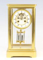 A late 19th century French lacquered brass four-glass mantel clock, having an unsigned white