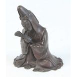 A Chinese bronze scroll weight, cast as a robed figure with fan in right hand, late Ming-Qing