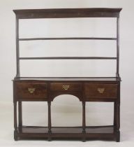 A George III joined oak Welsh dresser, having a three-tier plate rack over a base fitted with