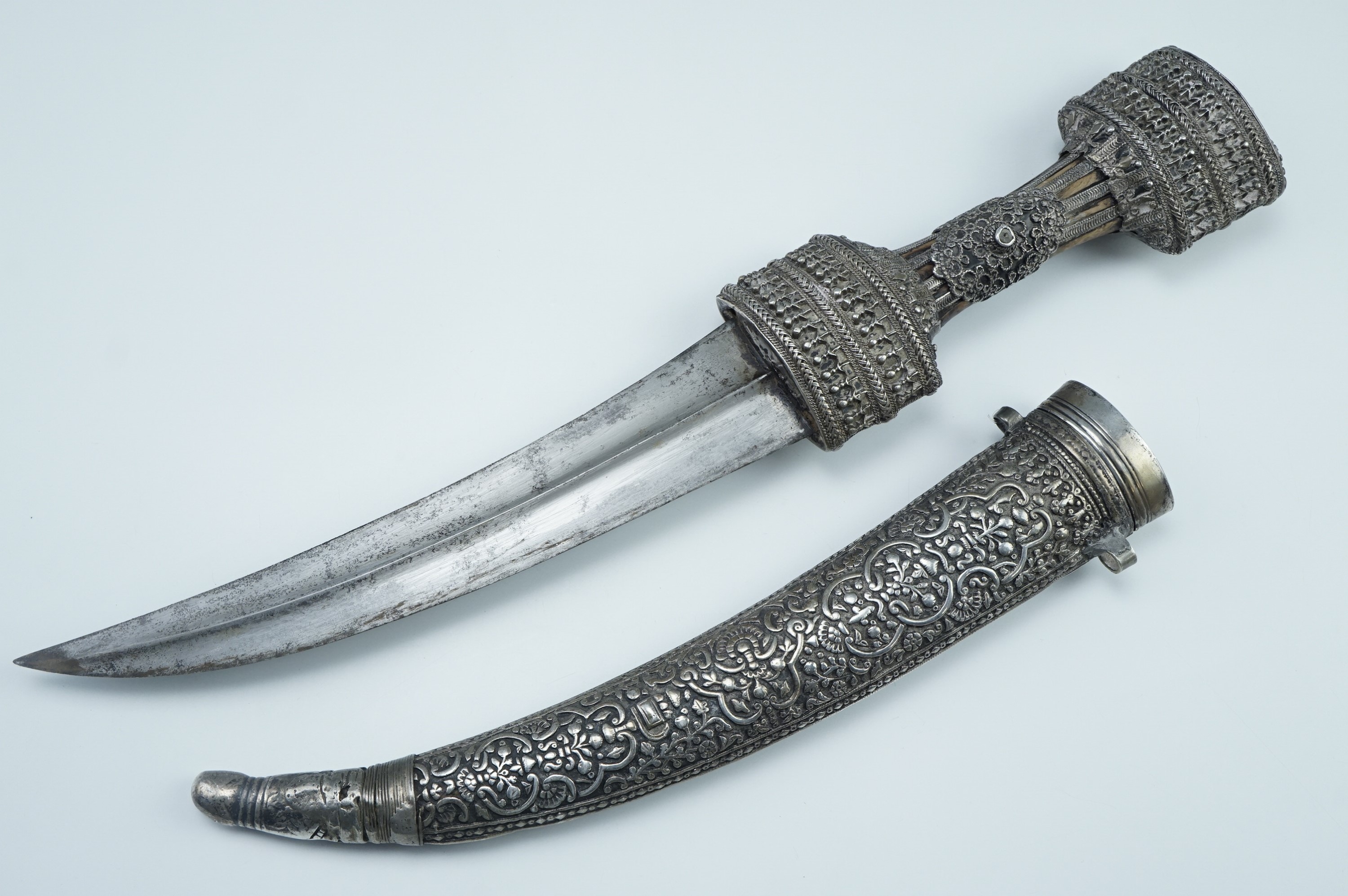 A fine late 19th / early 20th Century Middle Eastern jambiya dagger, the hilt bound in finely