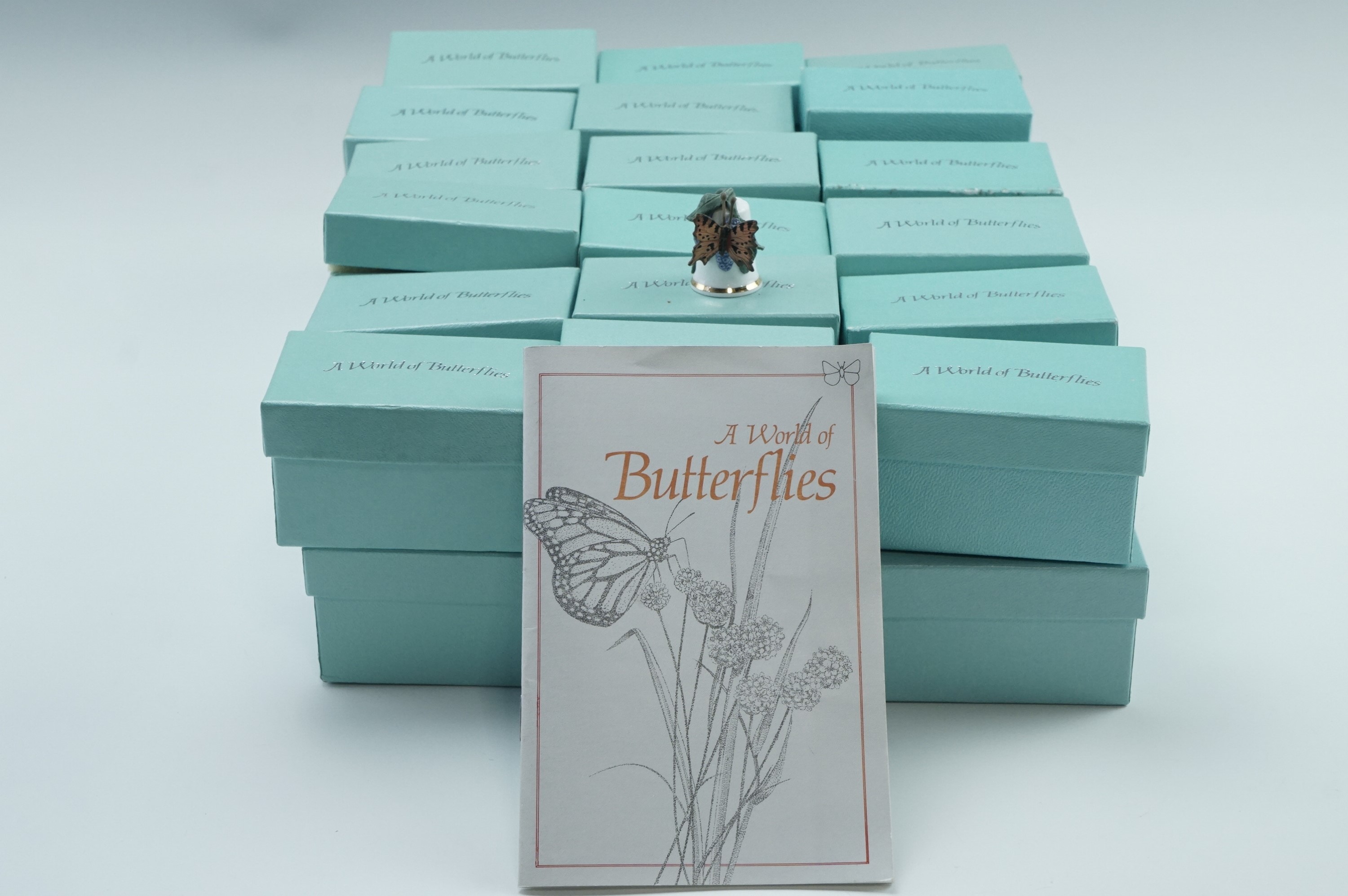 A quantity of World of Butterflies collector's thimbles and display stand
