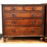 A George III mahogany cross banded oak chest of two over three drawers, having turned mahogany and
