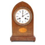 An Edwardian mahogany mantle clock, of lancet form having a drum movement striking on a gong, the