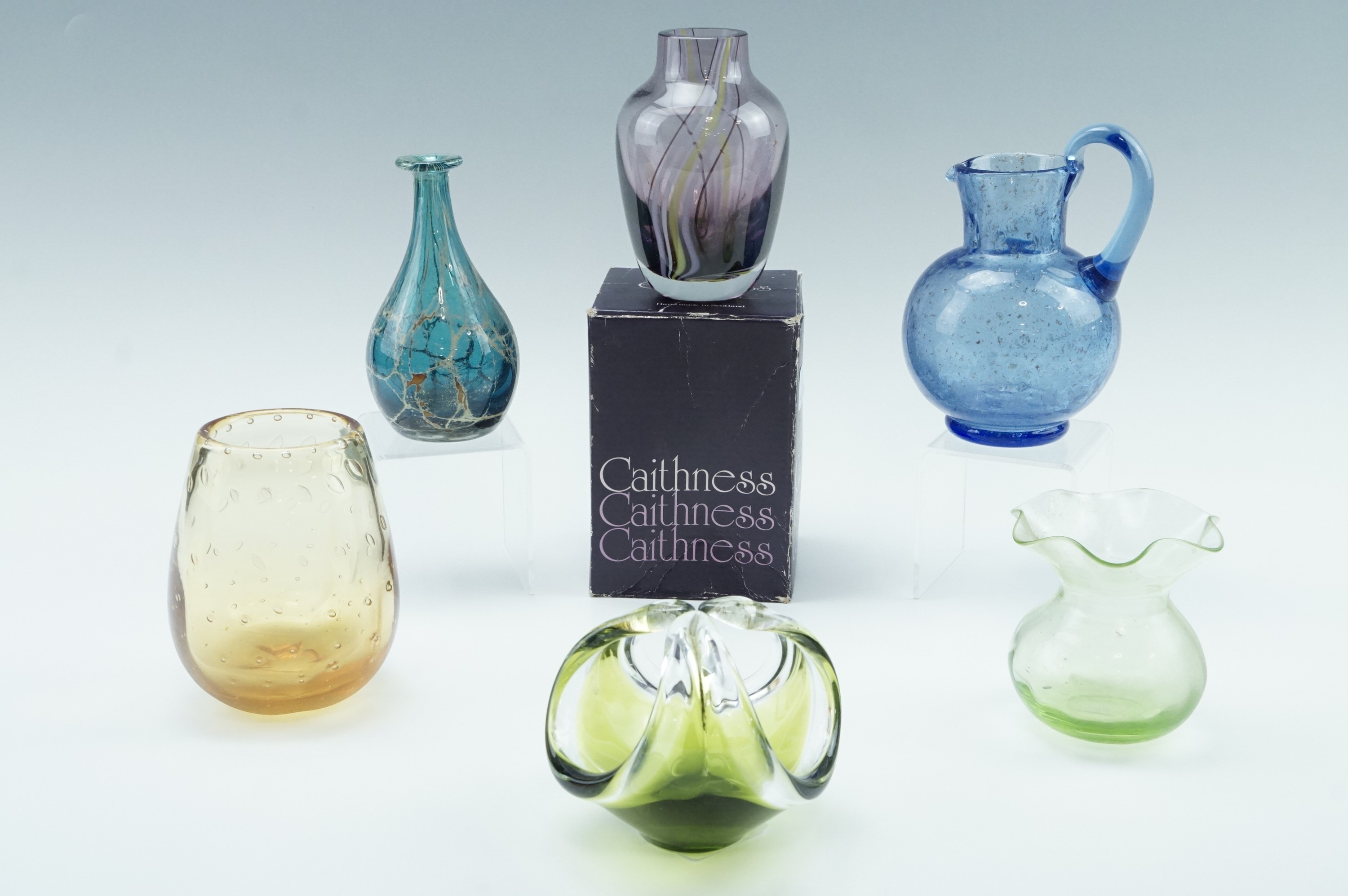 A Caithness vase, together with a Mdina bud vase, two vases, a jug etc, tallest 13 cm