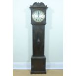 A 1930s oak grandmother clock, the movement striking on a gong and having a silvered dial, key