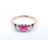 A 1920s ruby and chrysoberyl 9 ct yellow metal ring, having a square cut ruby flanked by two white