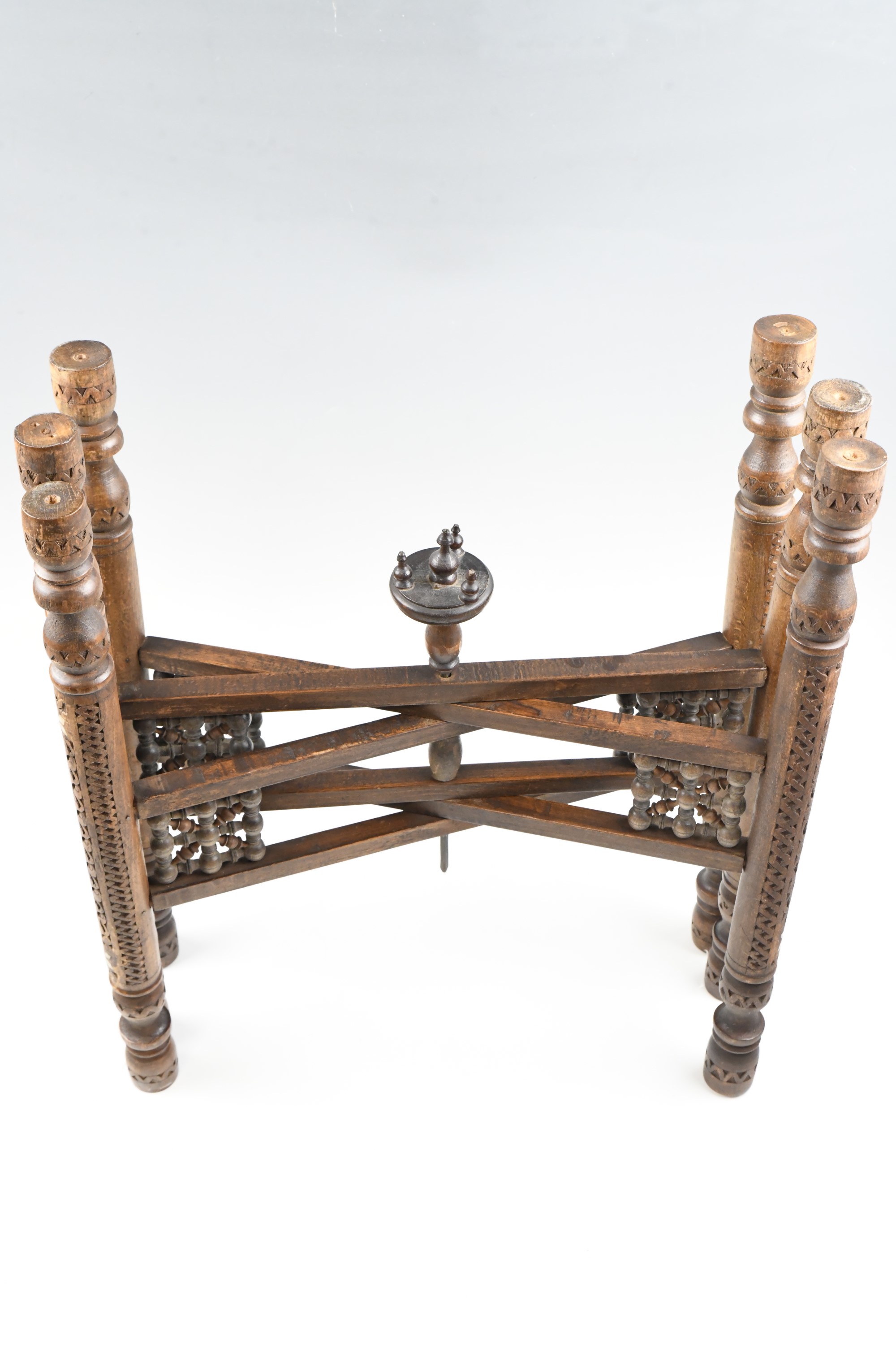 An early 20th Century Middle Eastern brass topped mother of pearl inlaid and carved folding table, - Image 3 of 3