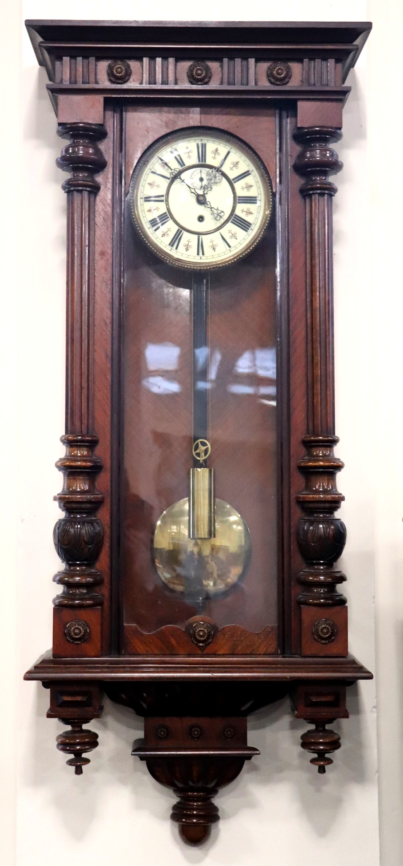 An early 20th Century single train walnut Vienna regulator, having a weight driven movement and an