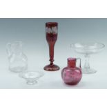 A group of Victorian and Edwardian glass comprising a ruby flashed and cut vase bearing fruiting