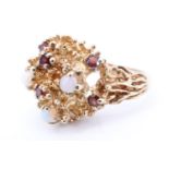 A 1970s naturalistic dress ring, formed with six small garnets and three opal cabochons enriching