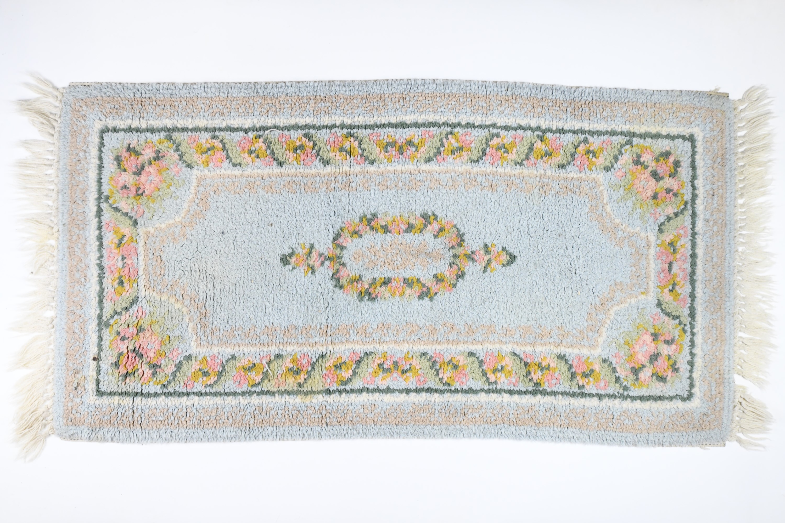 A wool pile rug, 135 cm x 72 cm