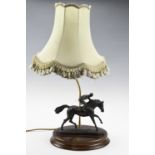 A figural table lamp, depicting horse and jockey, (a/f) 68 cm high