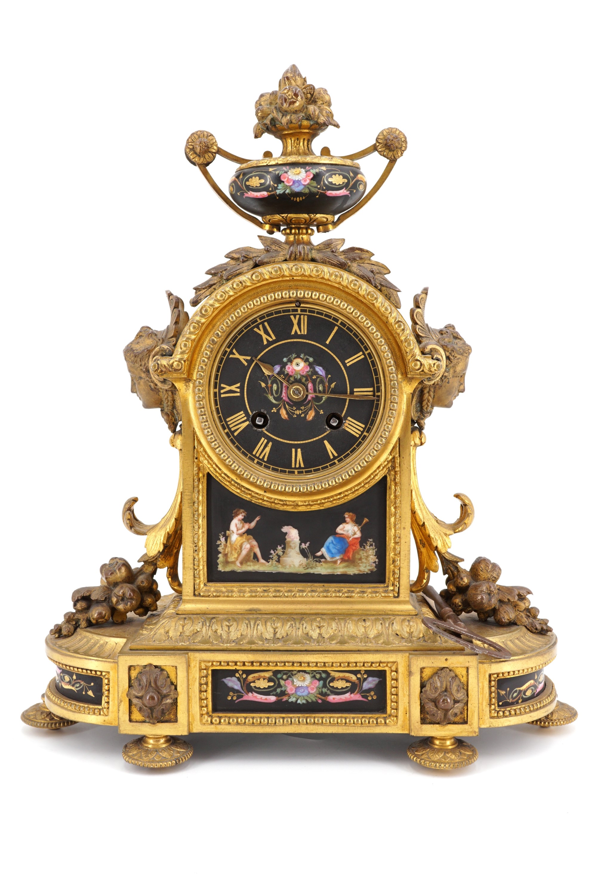 A 19th Century French gilt brass and enamel mantle clock, having a drum movement striking on a bell,
