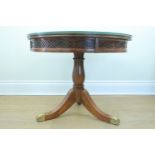 A reproduction Georgian style mahogany drum top coffee table, 67 x 56 cm