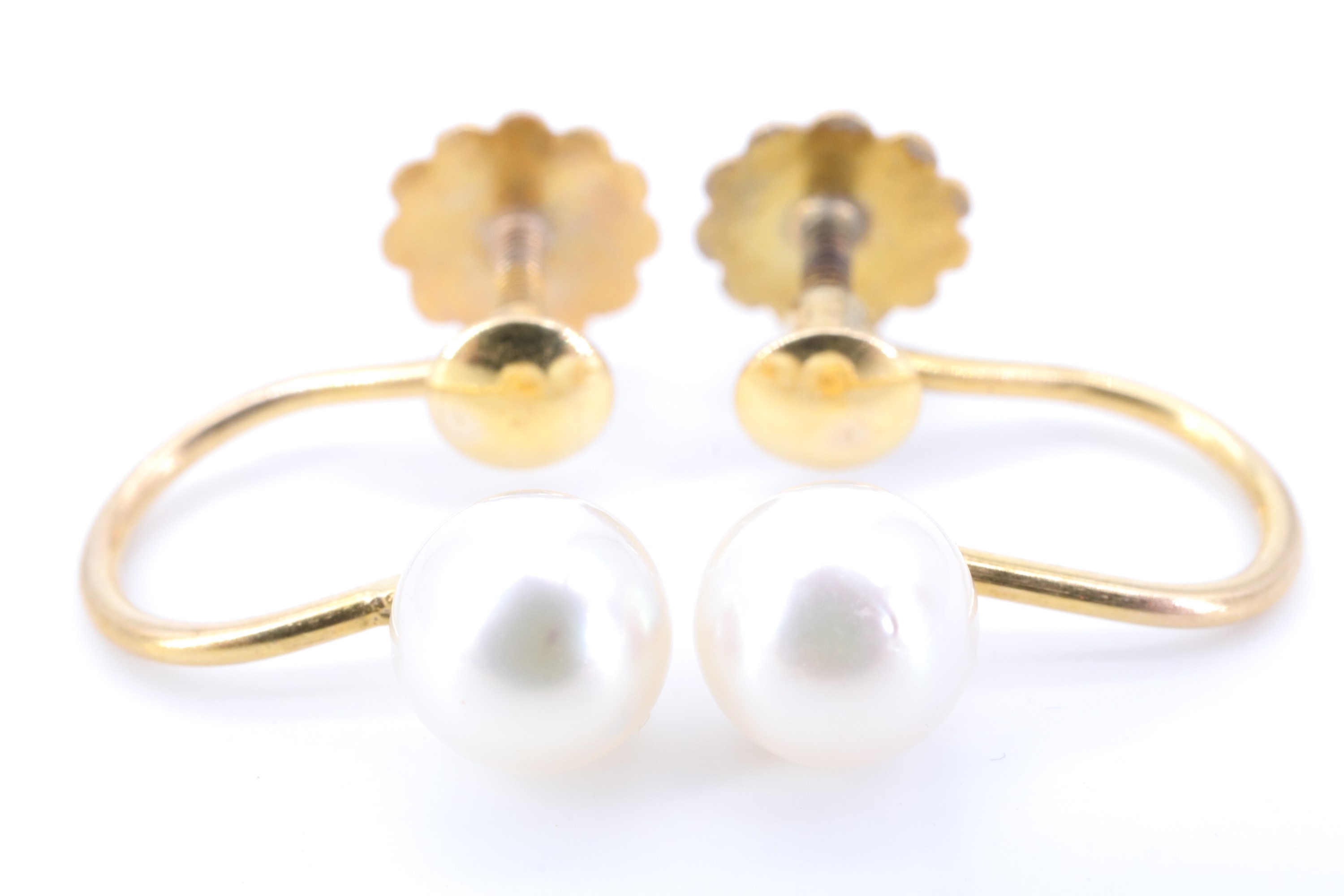 A pair of mid 20th Century pearl and 9 ct yellow metal earrings, having screw-backs marked '9ct',