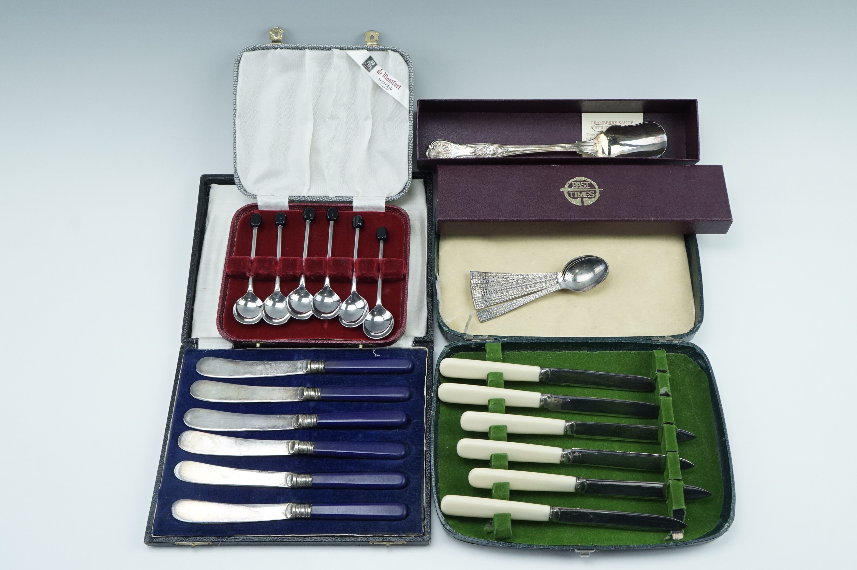 A set of 20th Century electroplated coffee spoons with bean terminals, two cased sets of tea knives,